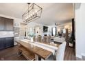 Bright dining area leading to a cozy living space, enhanced by a modern chandelier and stylish decor at 19149 Gillcrest Dr, Noblesville, IN 46062