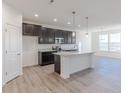 Modern kitchen with stainless steel appliances, gray cabinets, granite countertops, and a center island at 2150 Aviary Ln, Danville, IN 46122