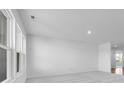 Spacious room with large windows, neutral carpet, and ample natural light at 2150 Aviary Ln, Danville, IN 46122