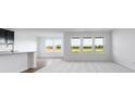 Bright living space with large windows offering views of green space, and new plush carpet at 2150 Aviary Ln, Danville, IN 46122