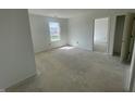 Light-filled bedroom with neutral walls, a window, and an open doorway at 24409 Stout St, Sheridan, IN 46069