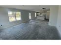 Spacious living room featuring bright windows and an open layout towards the kitchen at 24409 Stout St, Sheridan, IN 46069