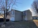 Exterior side view featuring neutral siding and well-manicured lawn at 2549 Black Antler Ct, Indianapolis, IN 46217