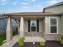 Inviting front porch with classic columns, brick accents and manicured landscaping at 275 Hunters Ridge Dr, Danville, IN 46122