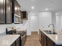 Well-equipped kitchen featuring stainless steel appliances, dark cabinets and countertops at 275 Hunters Ridge Dr, Danville, IN 46122