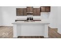 Modern kitchen with a large island, stainless steel appliances, and sleek countertops at 275 Hunters Ridge Dr, Danville, IN 46122