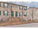 Inviting townhome with brick facade and green door and shutters at 3039 Armory Dr, Indianapolis, IN 46208