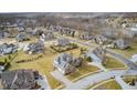 An aerial view of a residential neighborhood with well-maintained lawns and varied home styles at 3236 Wildlife Trl, Zionsville, IN 46077