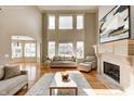 Bright living room with tall windows, fireplace, and neutral decor at 3236 Wildlife Trl, Zionsville, IN 46077