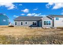 Backyard of a home featuring a lawn, surrounded by neighboring houses under a blue sky at 3687 Thomas Jefferson Ct, Westfield, IN 46074