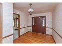 Traditional entryway featuring hardwood floors, classic wallpaper, and a stylish chandelier at 3810 Springfield Overlook St, Indianapolis, IN 46234