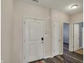 Inviting entryway featuring a white front door, wood floors, and neutral-colored walls at 4051 Presidio Cir, Indianapolis, IN 46235