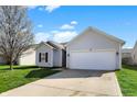 Charming single-story home with a well-maintained lawn and attached two-car garage at 4051 Presidio Cir, Indianapolis, IN 46235