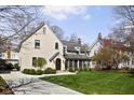 Inviting home with manicured lawn, screened porch, and curved driveway that adds to its charm and appeal at 4310 Central Ave, Indianapolis, IN 46205