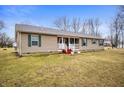 A ranch-style home featuring neutral siding, green shutters, and a well-maintained lawn at 4543 E 700 N, Alexandria, IN 46001