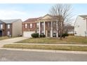 Beautiful brick two-story home with attached garage and landscaped front yard at 5630 N Rockingham Ln, McCordsville, IN 46055