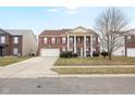Beautiful brick two-story home with attached garage and landscaped front yard at 5630 N Rockingham Ln, McCordsville, IN 46055