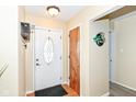 Bright foyer with a white front door, wood flooring, and modern decorations at 5924 Elaine St, Indianapolis, IN 46224