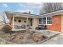 Inviting front porch with seating area, plants, and stylish decorative elements at 5924 Elaine St, Indianapolis, IN 46224