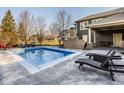 Sparkling pool featuring a brick fireplace and outdoor entertaining space at 6640 E Deerfield Dr, Zionsville, IN 46077