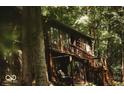 Wood cabin featuring rustic charm, surrounded by tall trees offering a peaceful escape to nature at 6688 Bellsville Pike, Columbus, IN 47201