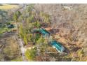 Aerial view of two green roof homes surrounded by trees at 7116 Grandview Rd, Columbus, IN 47201