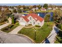 Aerial view of a lovely home with red roof overlooking the water in a quiet residential neighborhood at 7370 Chestnut Hills Blvd, Indianapolis, IN 46278
