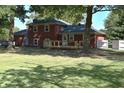 A well-manicured lawn in the backyard features a deck with an exterior view of a two-story home at 8143 Filly Ln, Plainfield, IN 46168