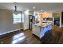 Spacious kitchen with stainless steel appliances, a granite island, recessed lighting and hardwood floors at 8143 Filly Ln, Plainfield, IN 46168