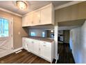 Bright kitchen features granite countertops, white cabinets and hardwood floors with views to the Living Room at 8143 Filly Ln, Plainfield, IN 46168