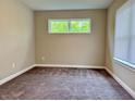 This carpeted bedroom features natural light from a window; fresh, neutral paint at 922 N Oakland Ave, Indianapolis, IN 46201