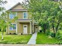 Two-story home with a landscaped yard and walkway leading to the front door at 922 N Oakland Ave, Indianapolis, IN 46201