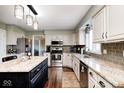 Beautiful kitchen features granite countertops, stainless steel appliances, and dark wood flooring at 933 Queensbury Dr, Noblesville, IN 46062