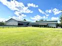 Large multi-purpose barn with a spacious green lawn, perfect for equestrian or agricultural activities at 9615 N County Road 150 E Rd, Pittsboro, IN 46167