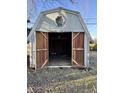 Rustic shed with open wooden doors and unique octagonal window, offering vintage charm at 9704 Porter Dr, Avon, IN 46123