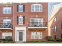Brick townhome featuring a private balcony, arched window, and classic architectural details at 100 11Th Nw St, Carmel, IN 46032