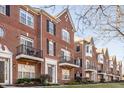 Row of brick townhomes with balconies and well-maintained landscaping creating desirable curb appeal at 100 11Th Nw St, Carmel, IN 46032