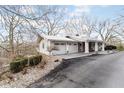 Spacious home with a two-car garage and stone landscaping surrounding the driveway and property at 1020 W Riverview Dr, Anderson, IN 46011