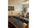 Entertainment bar features blue-tiled surface, sink, tap, and view into the living room with a projector at 11215 Cowan Lake Ct, Indianapolis, IN 46235