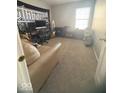 Comfortable bedroom with neutral carpet, a window for natural light, and ample space at 11215 Cowan Lake Ct, Indianapolis, IN 46235