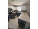 Well-lit kitchen featuring white cabinetry, stainless steel appliances, and a functional layout at 11215 Cowan Lake Ct, Indianapolis, IN 46235