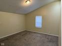 Bedroom featuring neutral carpet and a window with blinds, offering comfort and privacy at 1126 N Mitthoeffer Rd, Indianapolis, IN 46229