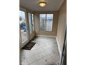 Sunroom featuring tile flooring and bright windows, perfect for enjoying natural light at 1126 N Mitthoeffer Rd, Indianapolis, IN 46229
