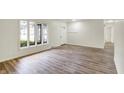 Open-concept living room featuring vinyl flooring, large windows, and neutral wall colors at 1157 Evans Ave, Noblesville, IN 46060