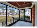 A relaxing sunroom offering natural light and views of the surrounding neighborhood at 1157 Evans Ave, Noblesville, IN 46060