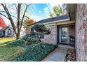 Inviting front entrance with brick facade, tidy landscaping, and a decorative evergreen tree at 12601 Slippery Rock Rd, Indianapolis, IN 46236