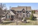 Stunning two-story brick home with meticulous landscaping, black shutters, and beautiful architectural details at 14034 Wicklow Ln, Fishers, IN 46040