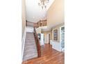 Spacious foyer features wood and carpet flooring, staircase with iron spindles, and ample natural light at 14034 Wicklow Ln, Fishers, IN 46040
