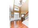 Welcoming foyer with high ceilings, chandelier, hardwood floors, and staircase with iron spindles at 14034 Wicklow Ln, Fishers, IN 46040