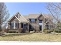 Beautiful brick home with manicured lawn, large windows, black shutters, and well-kept landscaping at 14034 Wicklow Ln, Fishers, IN 46040